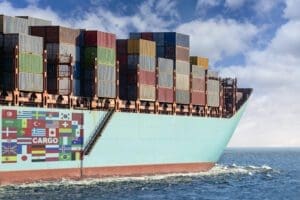 A cargo ship loaded with containers at sea.
