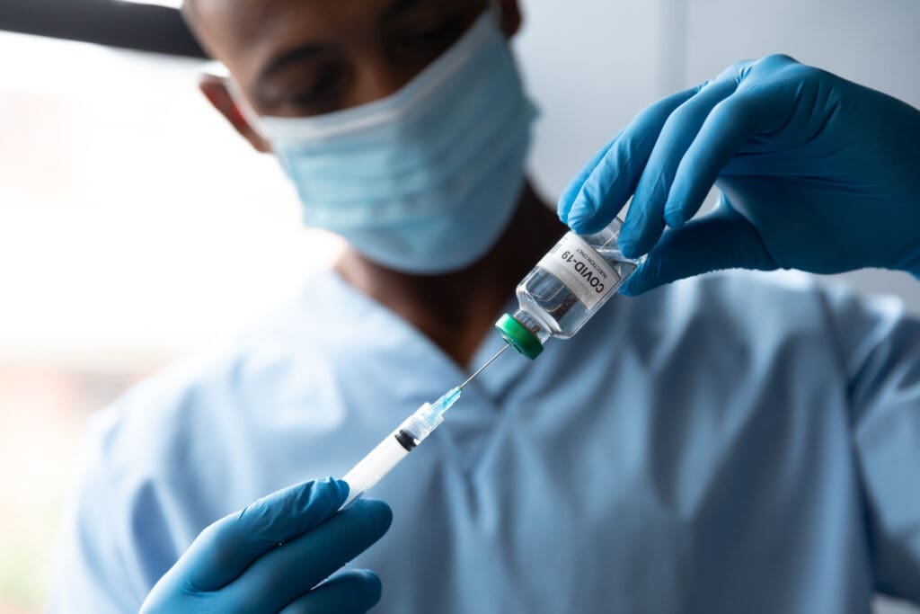 A doctor drawing a COVID-19 vaccine.