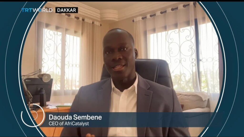 A man smiling in a suit, CEO of AfriCatalyst.
