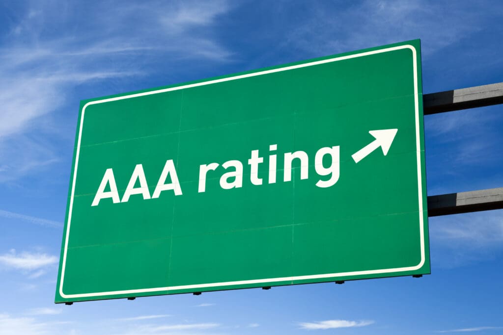 Green road sign with AAA rating arrow.
