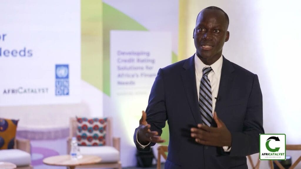 Man in suit speaking at a conference.