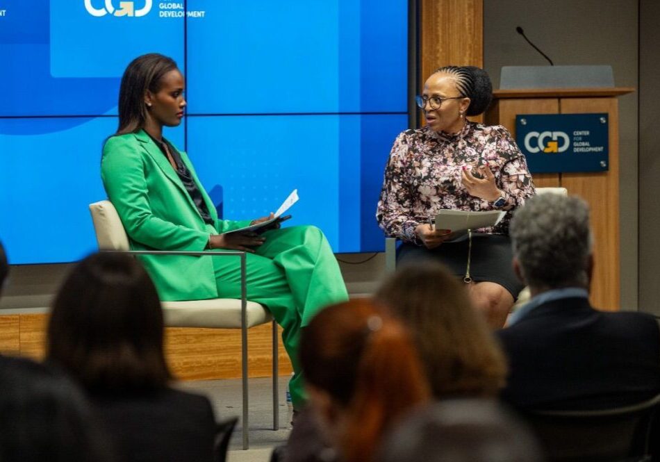 Two women speaking at a conference.