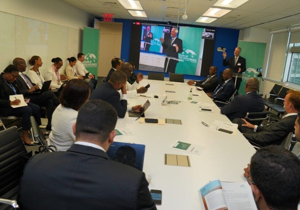 A group of professionals in a conference room watching a presentation.