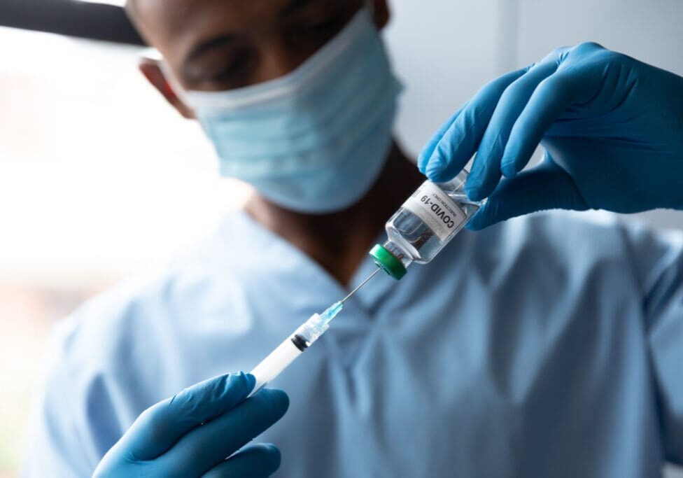 A doctor drawing a COVID-19 vaccine.