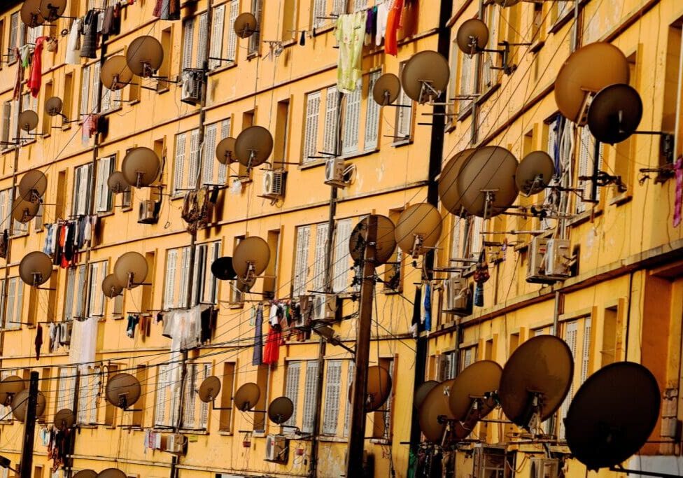 BEJAIA, ALGERIA -  AUGUST 5: August 5th, 2011, Town of Bejaia, Algeria. In the town of Bejaia, the inhabitants of this building could look out over the port and the sea, but the satellite dishes purchased at a price of gold and turned up to the sky obstruct almost all the windows. (Photo by Reza/Getty Images)