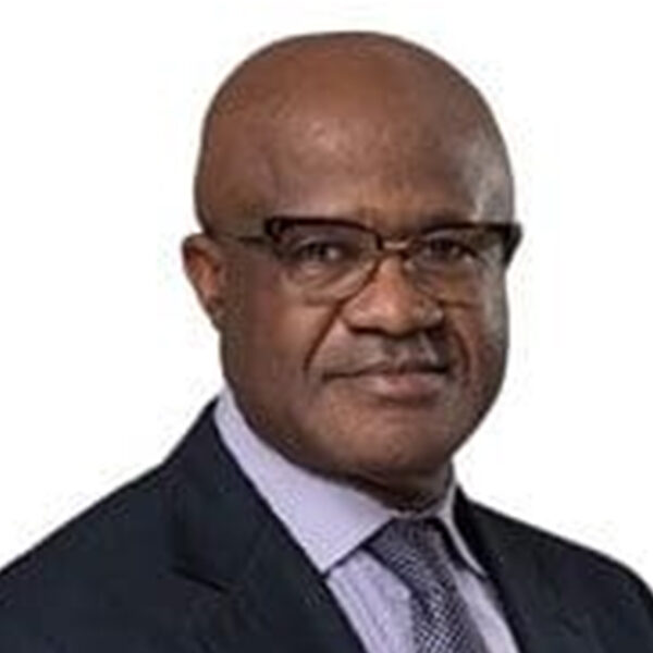 Man in suit and glasses looking at camera.