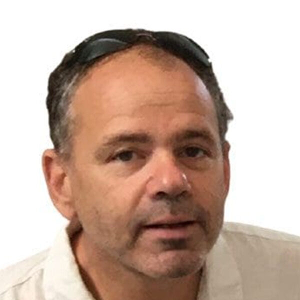 Portrait of a man with dark hair and glasses.