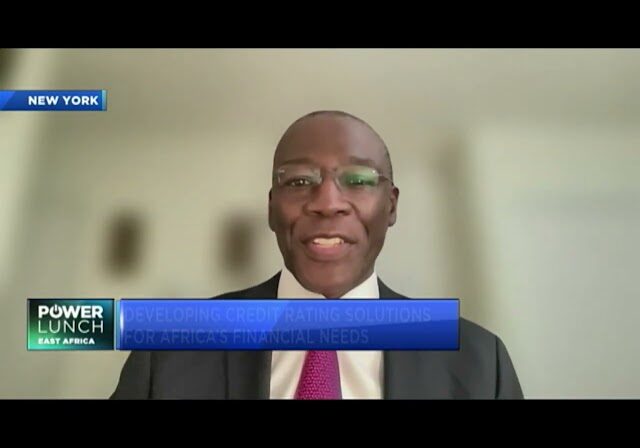 Man in suit speaking on camera.