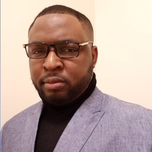 Man in a suit with glasses and a beard.