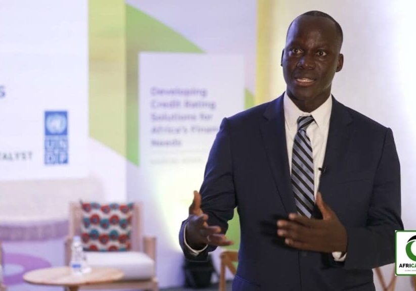 Man in suit speaking at a conference.