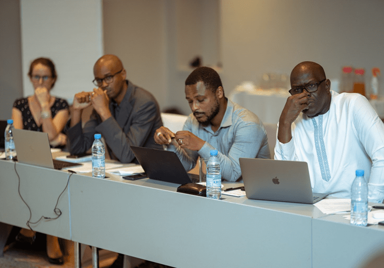 Professionals focusing on their work during a conference session.
