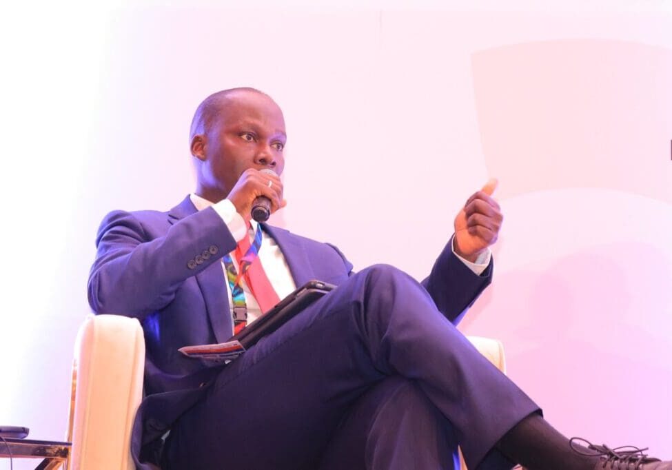 Man in suit speaking at a conference.