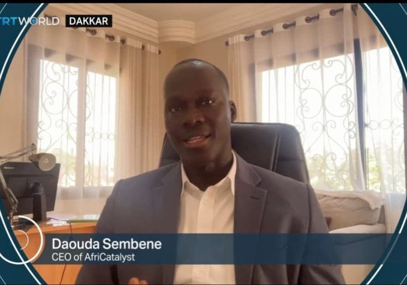 A man smiling in a suit, CEO of AfriCatalyst.