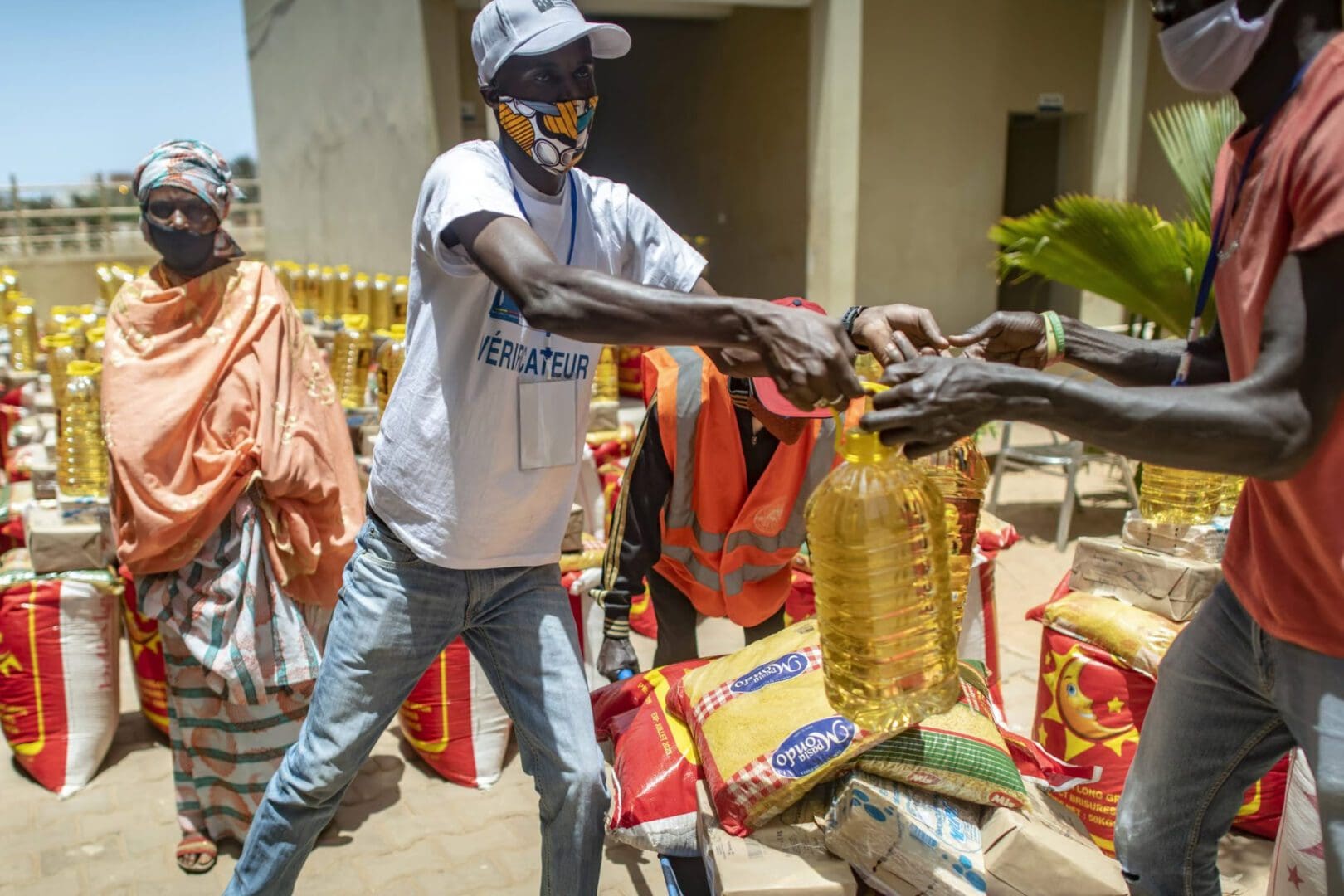 People distributing food and supplies during a relief effort.