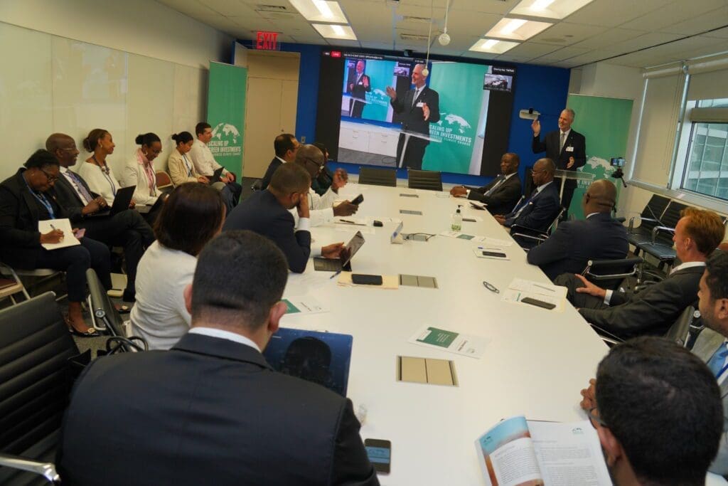 A group of professionals in a conference room watching a presentation.