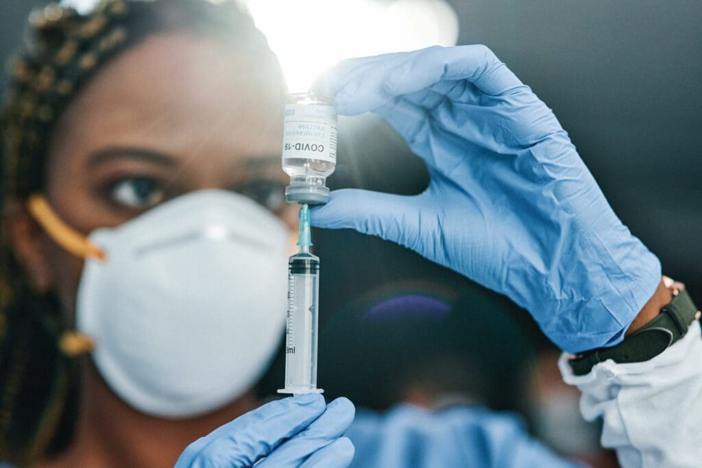 Healthcare professional preparing a vaccine dose for administration.