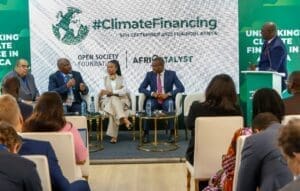 Panel discussion on climate financing at a conference in nairobi, kenya, with speakers and attendees engaging in dialogue.