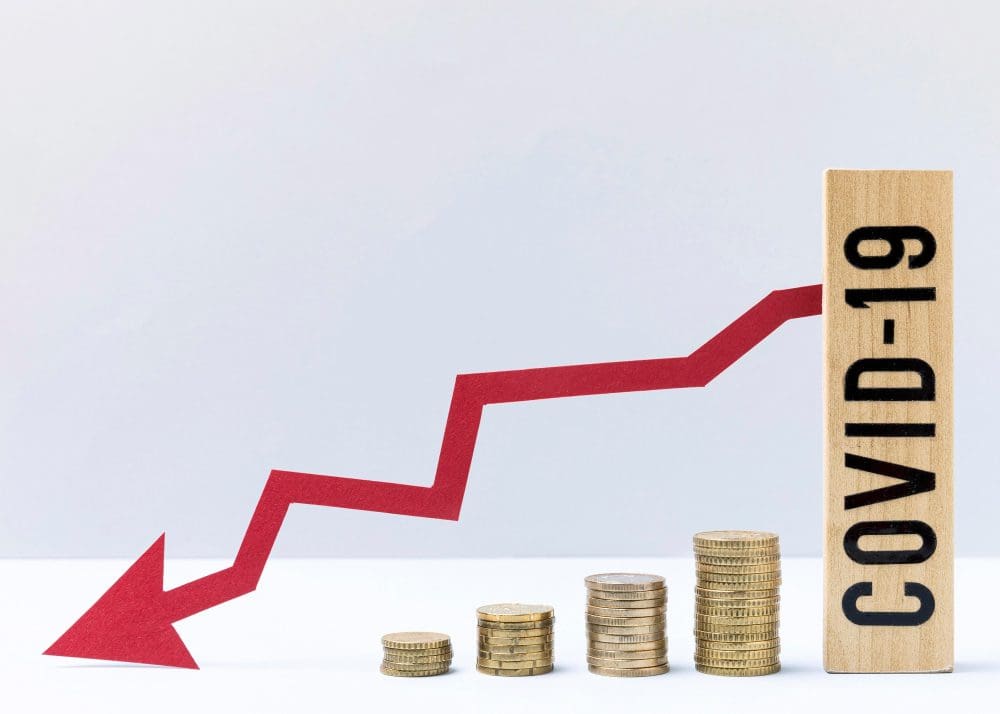 Declining financial graph with covid-19 indicating economic impact of the pandemic.
