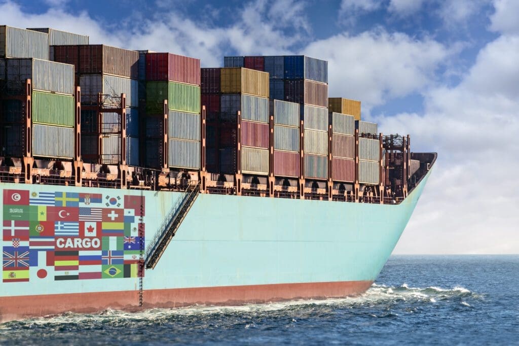 A cargo ship loaded with containers at sea.