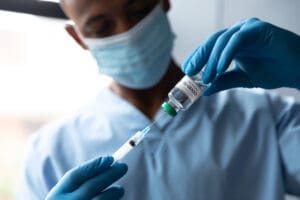 A doctor drawing a COVID-19 vaccine.