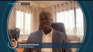 A man smiling in a suit, CEO of AfriCatalyst.