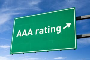 Green road sign with AAA rating arrow.