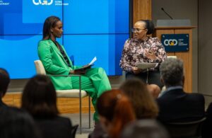 Two women speaking at a conference.