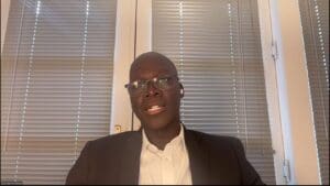Man in suit and glasses, video call.