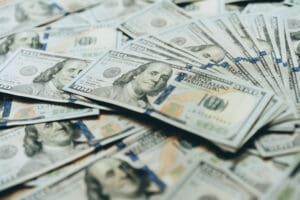Here's an alt tag for the image: Stack of one hundred dollar bills.