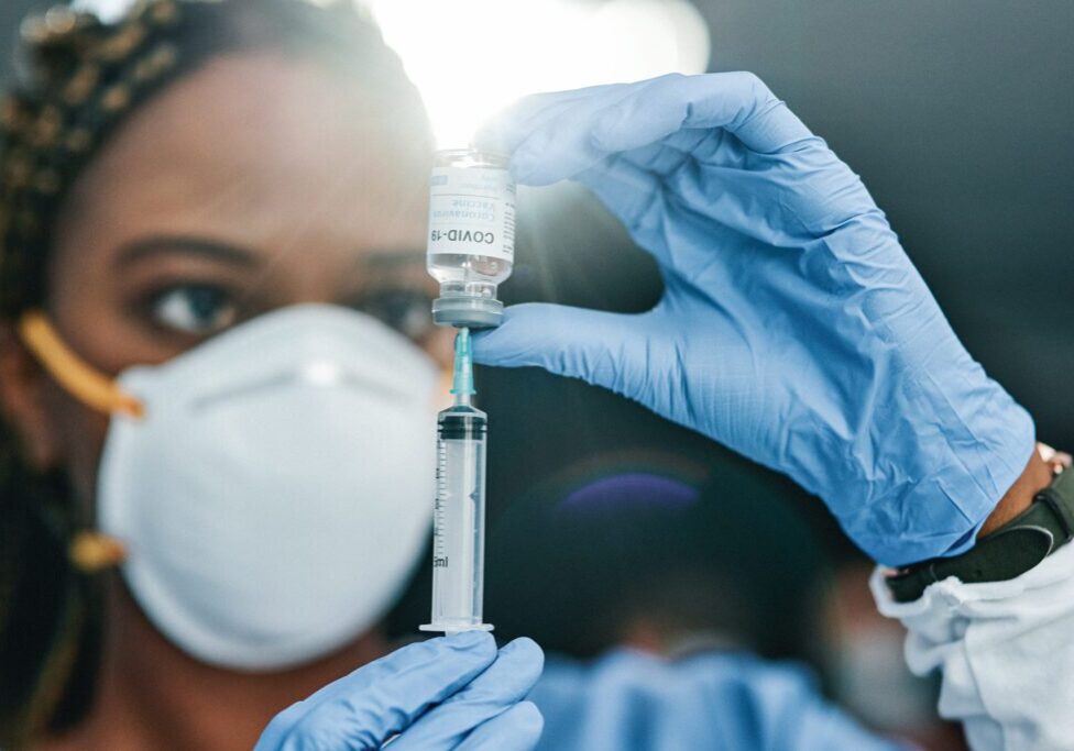 Healthcare professional preparing a vaccine dose for administration.