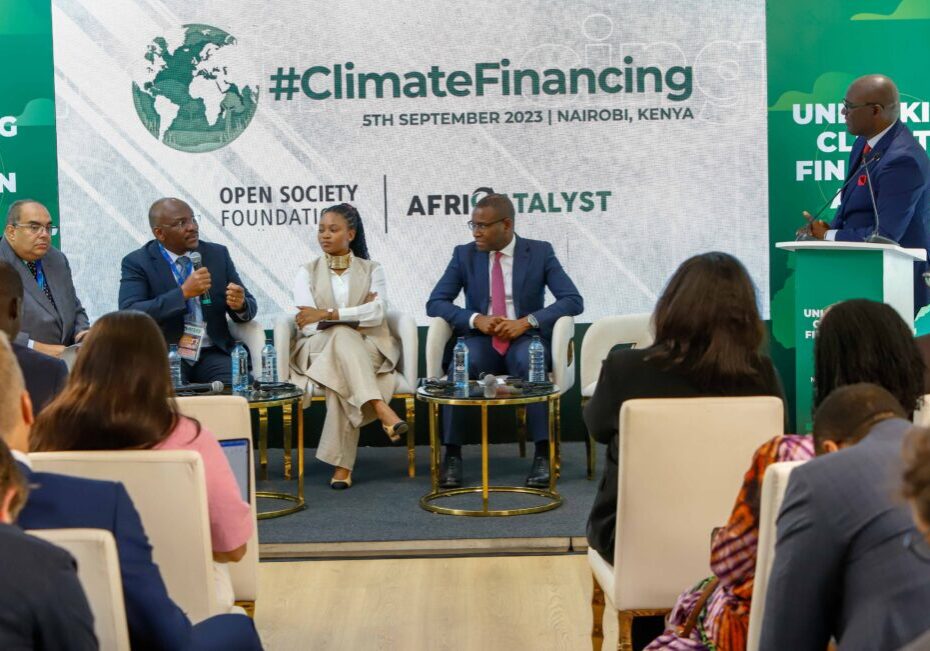 Panel discussion on climate financing at a conference in nairobi, kenya, with speakers and attendees engaging in dialogue.