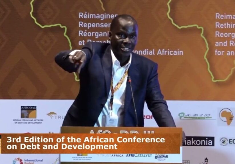 A speaker pointing towards the audience at the 3rd edition of the african conference on debt and development.