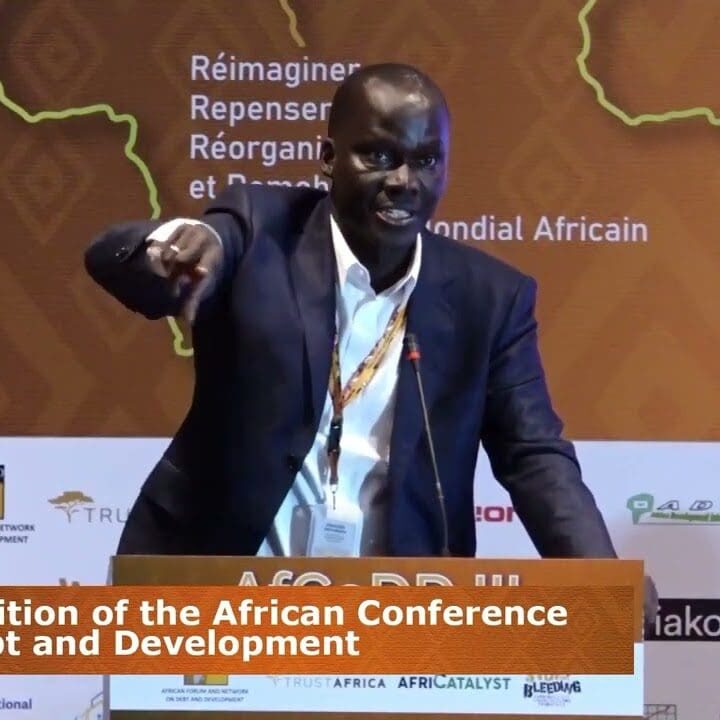 Man giving a presentation at the 3rd edition of the african conference on debt and development.